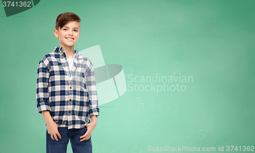 Image of smiling boy in checkered shirt and jeans