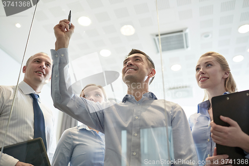 Image of smiling business people with marker and stickers