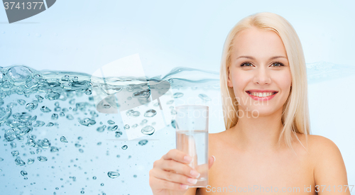 Image of young smiling woman with glass of water