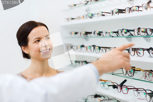 Image of woman with glasses and optician at optics store