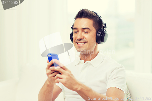 Image of happy man with smartphone and headphones