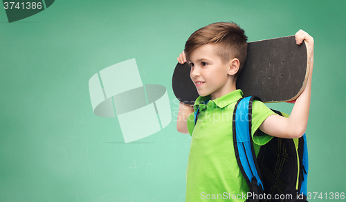 Image of happy student boy with backpack and skateboard