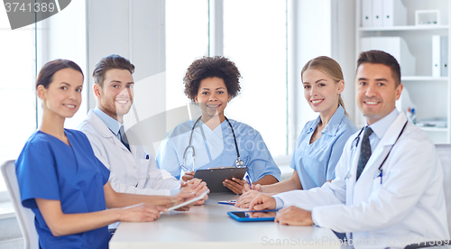 Image of group of happy doctors meeting at hospital office