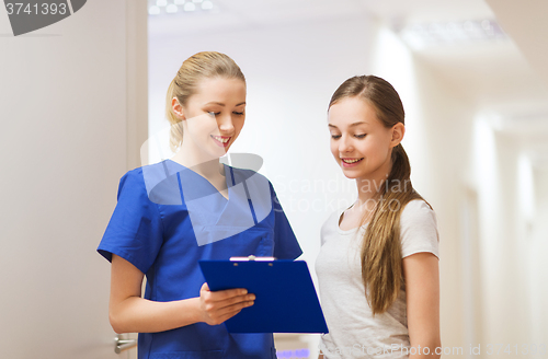 Image of doctor or nurse with clipboard and girl patient