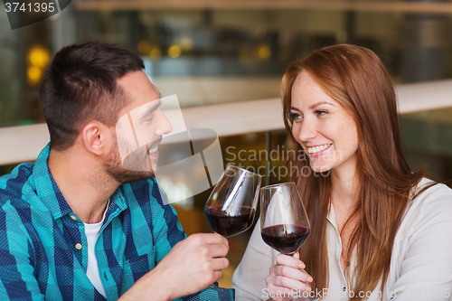 Image of happy couple dining and drink wine at restaurant
