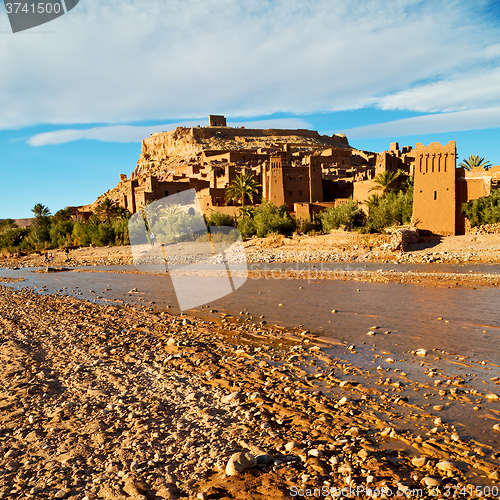 Image of sunset in africa old construction near the river blue