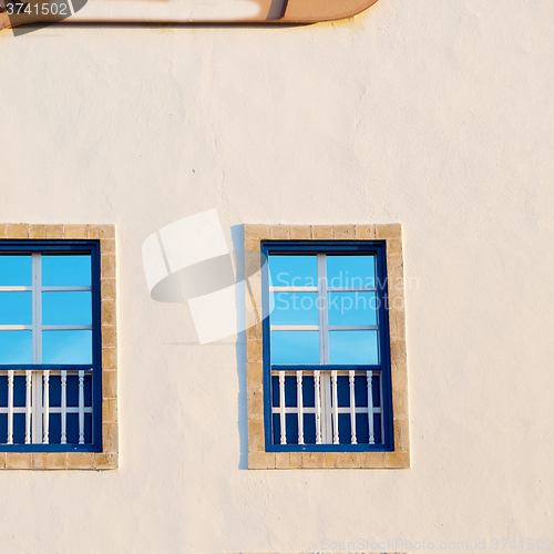 Image of blue window in morocco africa old construction and brown wall  c