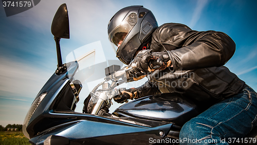 Image of Biker racing on the road