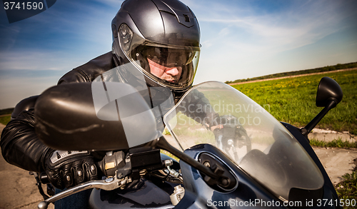 Image of Biker racing on the road