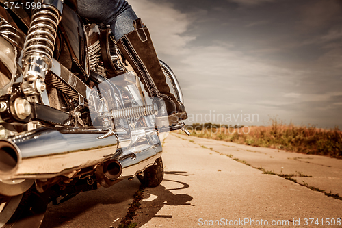 Image of Biker girl riding on a motorcycle