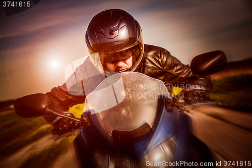 Image of Biker racing on the road