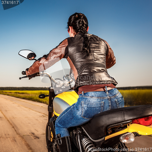 Image of Biker girl on a motorcycle