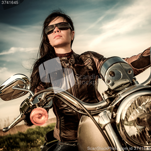 Image of Biker girl on a motorcycle