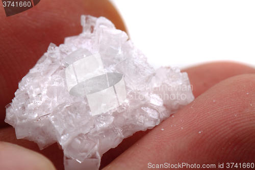 Image of natural salt crystal in human hand