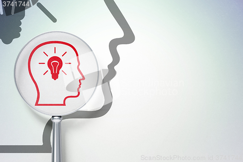 Image of Learning concept:  Head With Lightbulb with optical glass on digital background