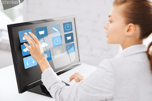 Image of businesswoman with computer touchscreen in office