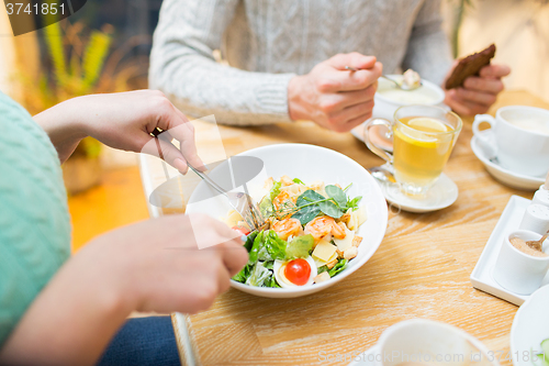 Image of close up friends having dinner at restaurant