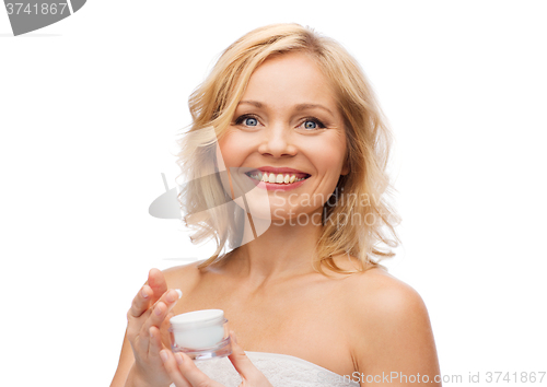 Image of happy woman with cream jar
