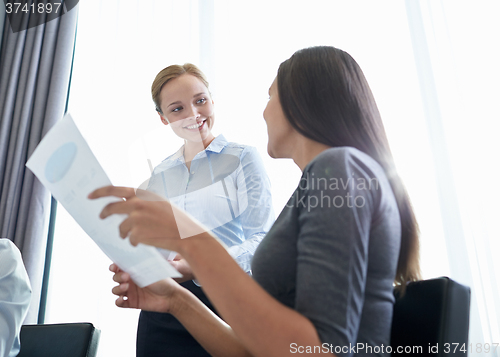 Image of smiling businesswomen meeting in office