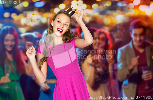 Image of happy young woman in princess crown at night club