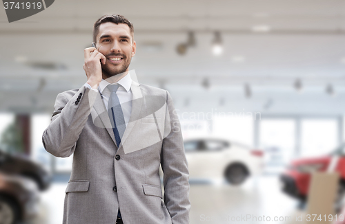 Image of smiling businessman talking on smartphone