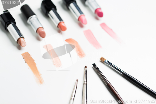 Image of close up of lipsticks range with makeup brushes