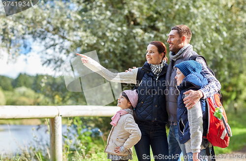 Image of happy family with backpacks hiking