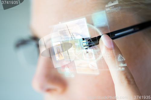 Image of close up of woman in glasses with virtual screen