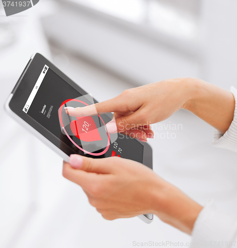 Image of close up of hands with heart icon on tablet pc