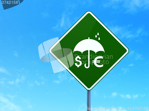 Image of Privacy concept: Money And Umbrella on road sign background