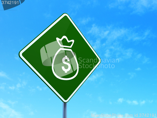 Image of Currency concept: Money Bag on road sign background