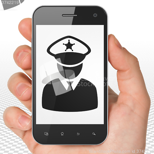 Image of Protection concept: Hand Holding Smartphone with Police on display