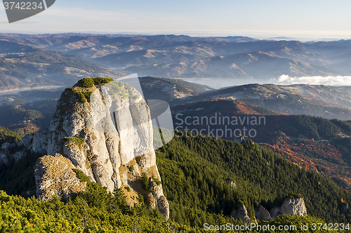 Image of Rocky peak and autumn forest