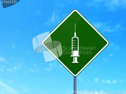 Image of Healthcare concept: Syringe on road sign background