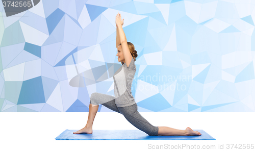 Image of happy woman making yoga in low lunge on mat