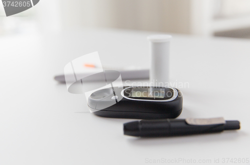 Image of close up of glucometer and blood sugar test stick