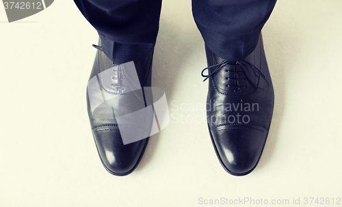 Image of close up of man legs in elegant shoes with laces