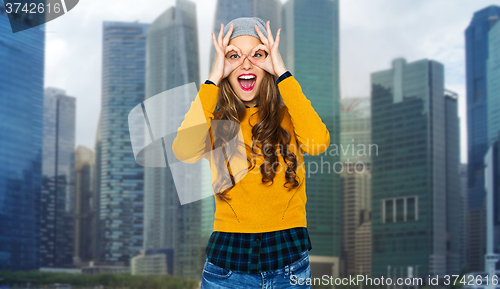 Image of happy young woman or teen having fun over city