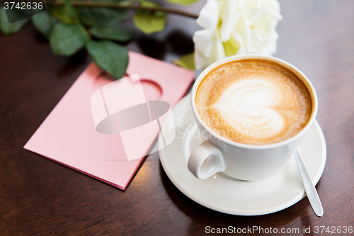 Image of close up of greeting card with heart and coffee