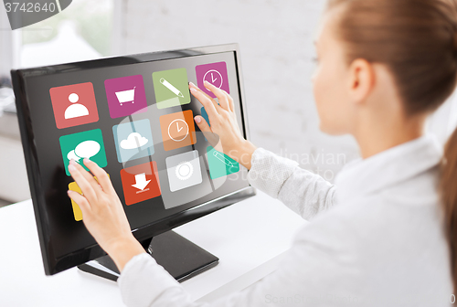 Image of businesswoman with computer touchscreen in office