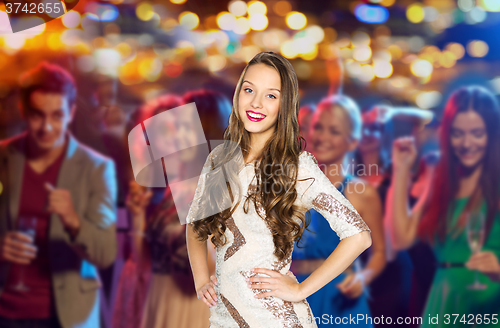 Image of happy young woman or teen girl at disco club