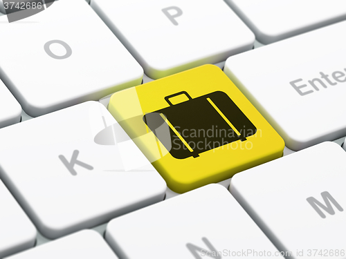 Image of Tourism concept: Bag on computer keyboard background