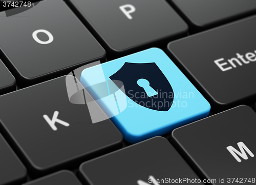 Image of Protection concept: Shield With Keyhole on computer keyboard background