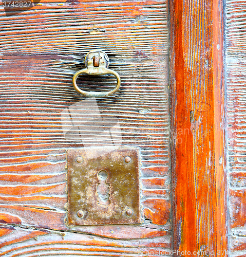 Image of  varese abstract  rusty brass brown knocker in a    