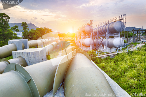 Image of Oil and gas industry refinery factory at sunset