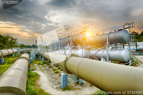 Image of Oil and gas industry refinery factory at sunset