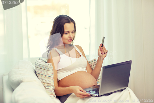 Image of pregnant woman with laptop and ultrasound image