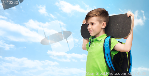 Image of happy student boy with backpack and skateboard