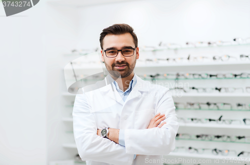 Image of man optician in glasses and coat at optics store