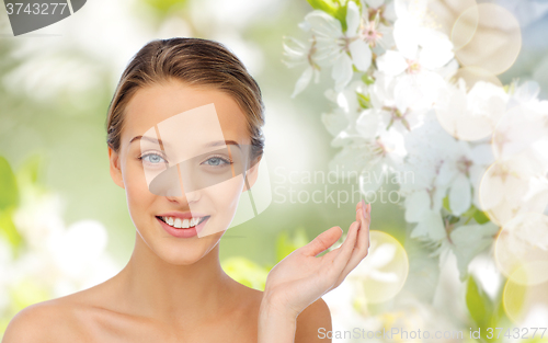 Image of smiling young woman face and shoulders